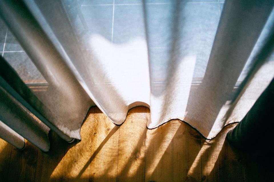 Light filtered through linen curtains